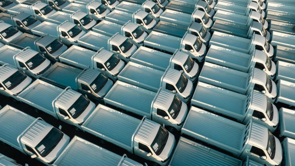 Maximizing Your Blog’s Reach: SEO Tips for Bloggers A top-down view of numerous white trucks parked in a grid pattern, showing symmetry and industrial logistics.