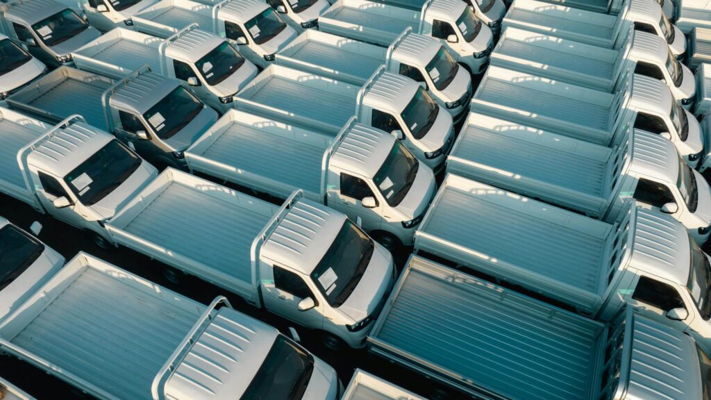 Never Run Out of Ideas: Top Tips for Generating Fresh Blog Topics Aerial view of white pickup trucks parked in rows, emphasizing symmetry and industrial style.